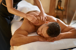Person Massaging Man's Shoulder